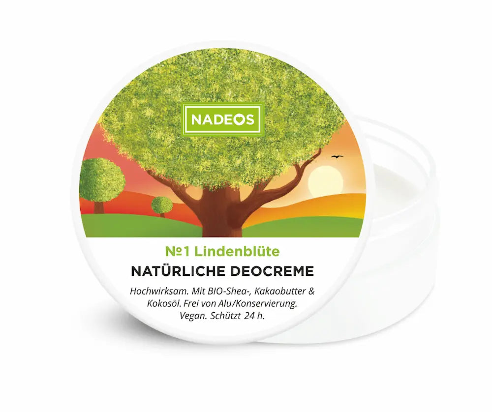 Geöffnete weiße NADEOS Deocreme-Dose Nr. 1 Lindenblüte mit cremigem Inhalt, Deckel mit Baummotiv im Sonnenuntergang